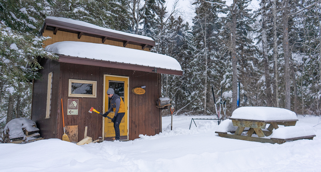 chopping wood outside cabin