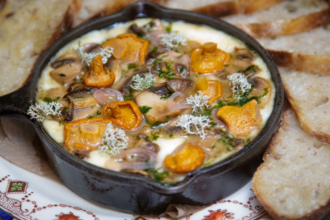 a dish of food with bread on a plate