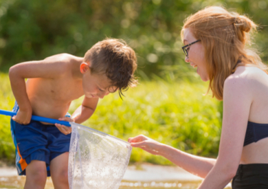 Woman and child using a net to sift water
